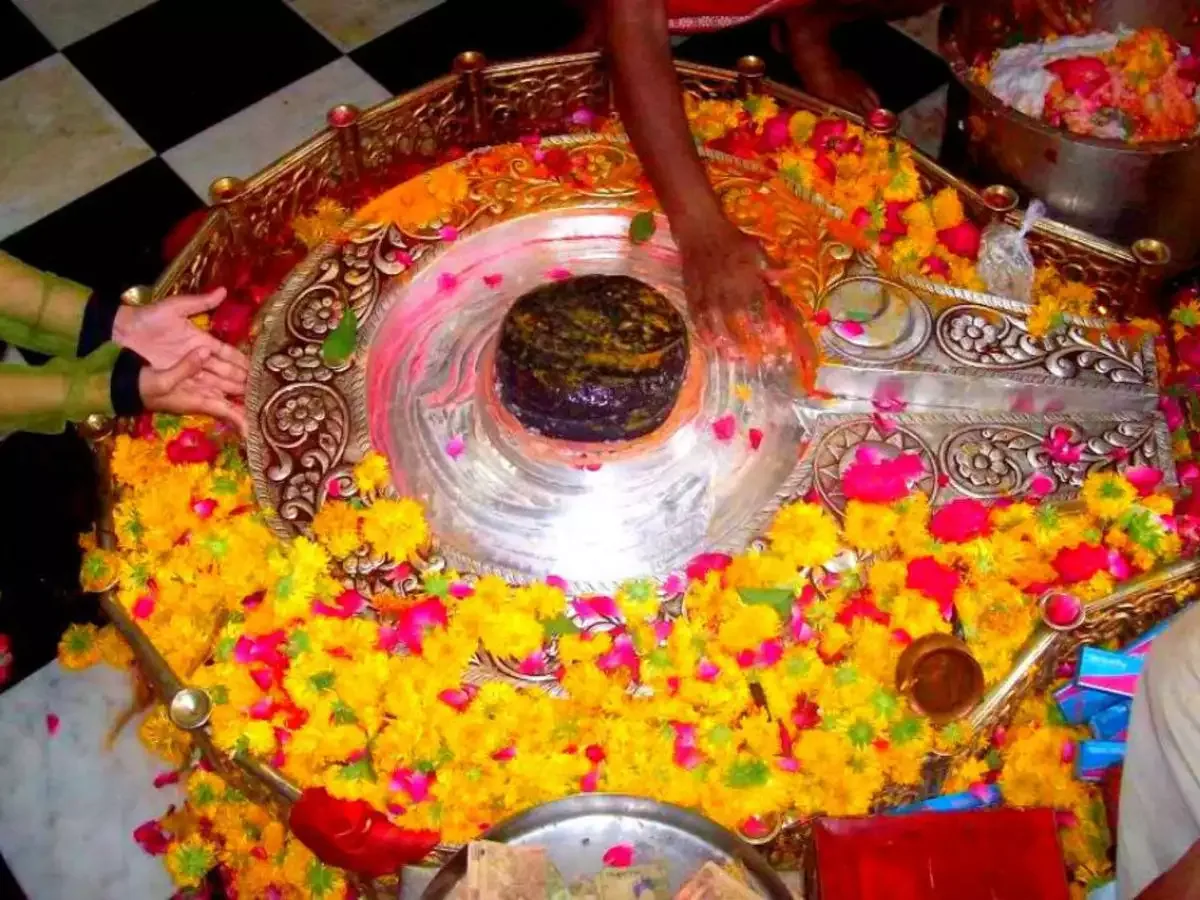 Shiva linga decorated with flowers during abhishek at Mangal Nath Mandir